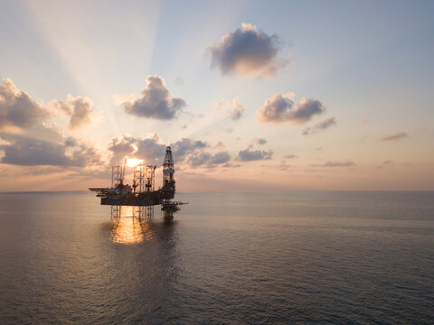Offshore Jack Up Rig in The Middle of The Sea at Sunset Time for Petroluem Exploration and Production