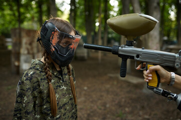 Shot from paintball gun in the girl's face in mask