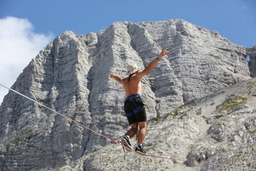 A man ziplines in the mountains