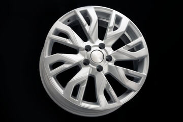 car alloy wheel, new, beautiful, unusual modern silver on a black background