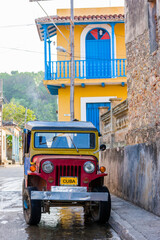 Colorful image of old car and tropical houses