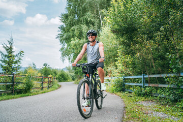 Portrait of a happy smiling man dressed in cycling clothes, helm