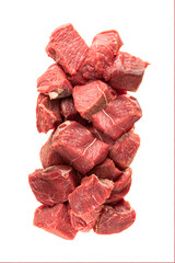 large sliced cubes of red meat beef or pork, a portion of igredient for cooking or diain packaging. vertical photo. the meat pieces are stacked in a vertical block, ready-packed portion