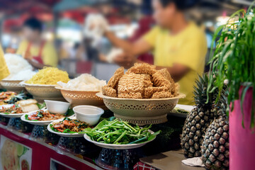 noodles and traditional Thai food are served in portions at an open market in Phuket, local fast food