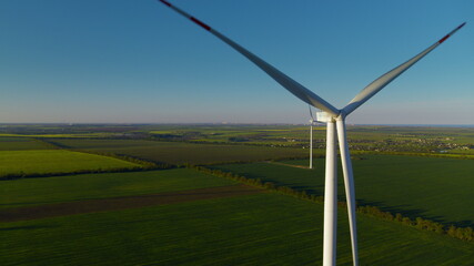 Aerial view of technological wind towers operating. Windmills producing power.