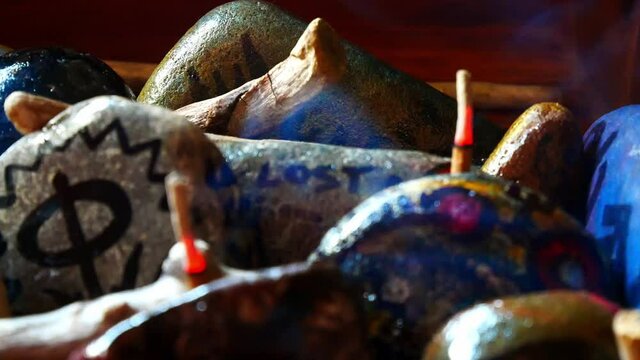 Esoteric painted Viking drawing patterned spiritual stones colourful hobby art collection in wooden box with burning incense