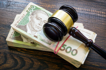 Ukrainian hryvnia money and a gavel. Bribery and corruption in court.