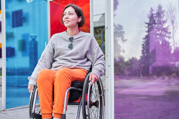 Disabled woman with loss of leg function sitting at the wheelchair