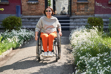 Woman looking at the camera and moving herself at the special armchair while enjoying