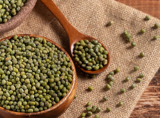 Close up of raw mung bean on wooden table background.