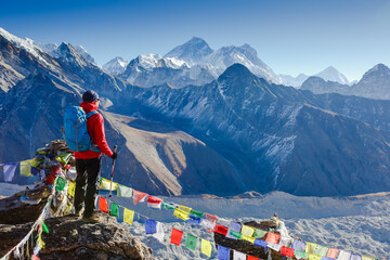 Active hiker hiking, enjoying the view, looking at Himalaya mountains landscape. mountaineering...