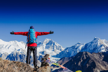 Happy man Traveler with Backpack hiking in Himalayas. mountaineering sport lifestyle concept