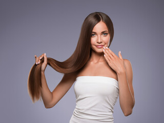 Fototapeta premium Woman with long smooth hair breunette natural make up healthy skin manicure nails