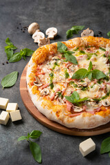Pizza with ham and champignon mushrooms. Ingredients around. Italian food.