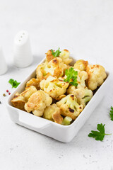 Fried cauliflower nuggets in baking dish. Space for text.