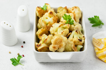 Fried cauliflower nuggets in baking dish. Space for text.