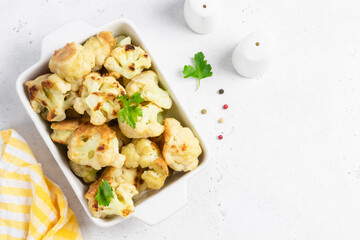 Buffalo cauliflower bites in baking dish. Space for text, top view.