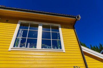 Window on yellow house wall