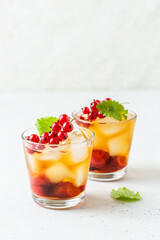 Kombucha mocktail, summer party drink, berry iced tea in glasses. Space fot text.