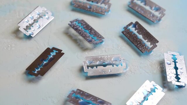 Razor blades with water droplets. Rotation