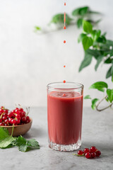 Red currant, raspberry, blackberry and blueberry smoothie. Transparent glass of berry healthy drink with bamboo tube