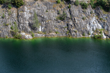 The green lake in the marble quarry with crystal clear water. Rocky mountain landscape. 
