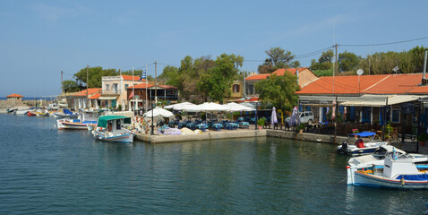 Fototapeta na wymiar Molyvos Harbour with fishing boats and Restaurants 