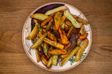 homemade healthy french fries and sweet potato with parsley on a plate