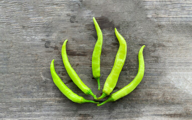 Banana Pepper isolated against a wood background