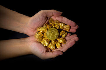 Holding a close-up of gold and bitcoin, the theme of financial concept