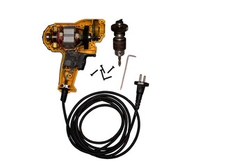 detachable used electric drill on white background The lid opens to reveal the internal components that include the motor, gear and switch.