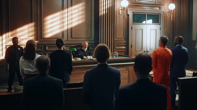 Court of Law and Justice Trial: Imparcial Honorable Judge Pronouncing Sentence, Striking Gavel. Cinematic Shot of Male Lawbreaker in Orange Robe Sentenced to Serve Time in Prison. Hearing Adjourned,