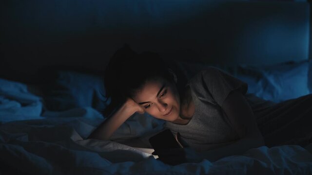 gadget dependency internet addict woman phone bed