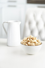 Dry breakfast cereal pads with milk on a light table. selective focus