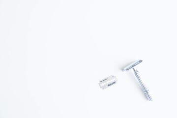 Vintage safety metal razor on a white background. Close-up. Isolated on white background. Reusable blade, zero waste product
