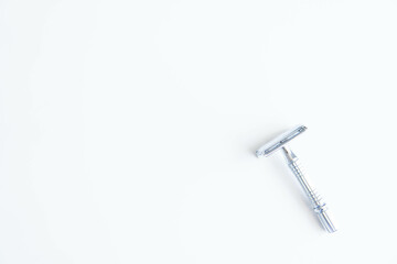 Vintage safety metal razor on a white background. Close-up. Isolated on white background. Reusable blade, zero waste product
