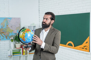 mature bearded teacher with beard and moustache wear suit in school classroom, education