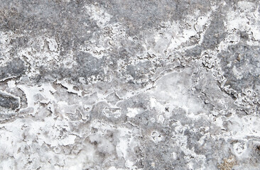 the sea coast in the form of bottom sediments flooded with seawater with the formation of salt patterns and sea lagoons in the form of textures and stone abstractions under water with shadows from the