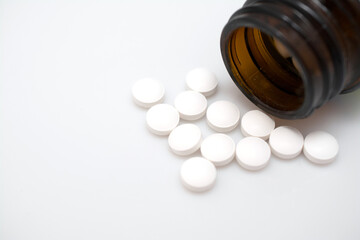 white pills on white