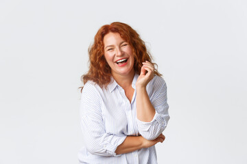 Beauty, lifestyle and aging concept. Portrait of attractive middle-aged lady laughing out loud,...