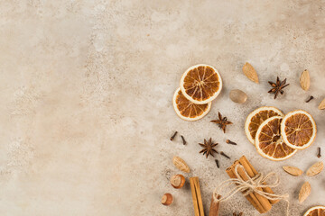 Cinnamon sticks, slices of dried orange, star anise. Top view. Autumn background. The concept of celebrating Christmas.