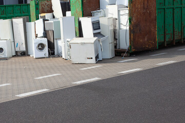 Old electrical appliances, washing machines in container. ELECTRONIC WASTE. - obrazy, fototapety, plakaty