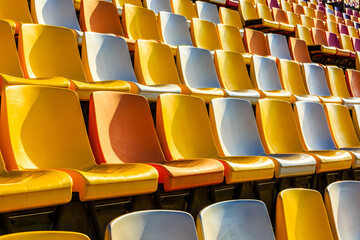 Fototapeta na wymiar Empty plastic chairs in the stadium.