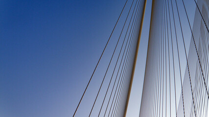 Fototapeta na wymiar Cables of a suspension bridge over sky