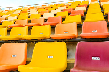 Empty plastic chairs in the stadium.