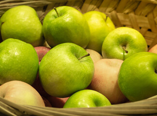 Fresh green organic apples in basket ready to eat.