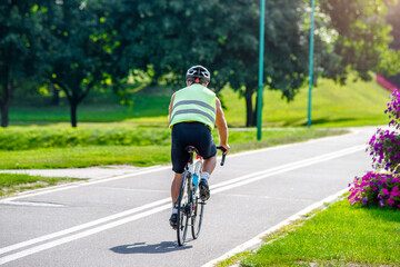 Fototapeta na wymiar Cyclist ride on the bike path in the city Park 