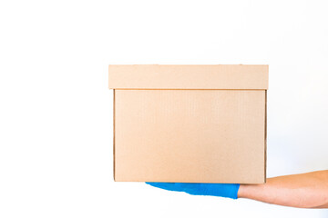 Delivery man holding cardboard boxes in blue rubber gloves with copy space. Fast and free Delivery transport . Online shopping and Delivery service concept