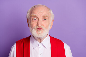 Photo of cheerful old happy positive man good mood make funny face grimace isolated on purple color...