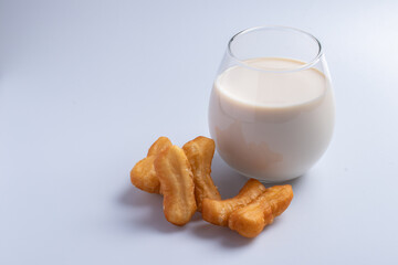 Fresh milk in a clear glass with Patongo.Thailand street food is call 